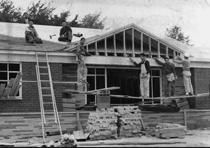 Black-and-white 1950s roofing crew on the job