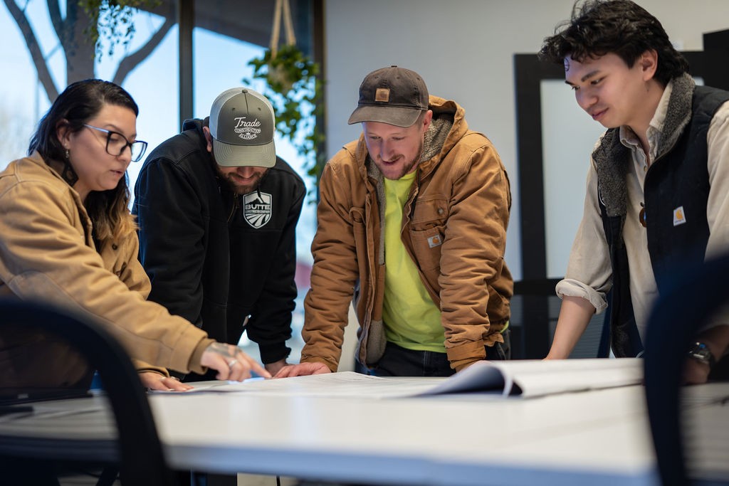 Butte Construction team gathered around a conference table reviewing project plans